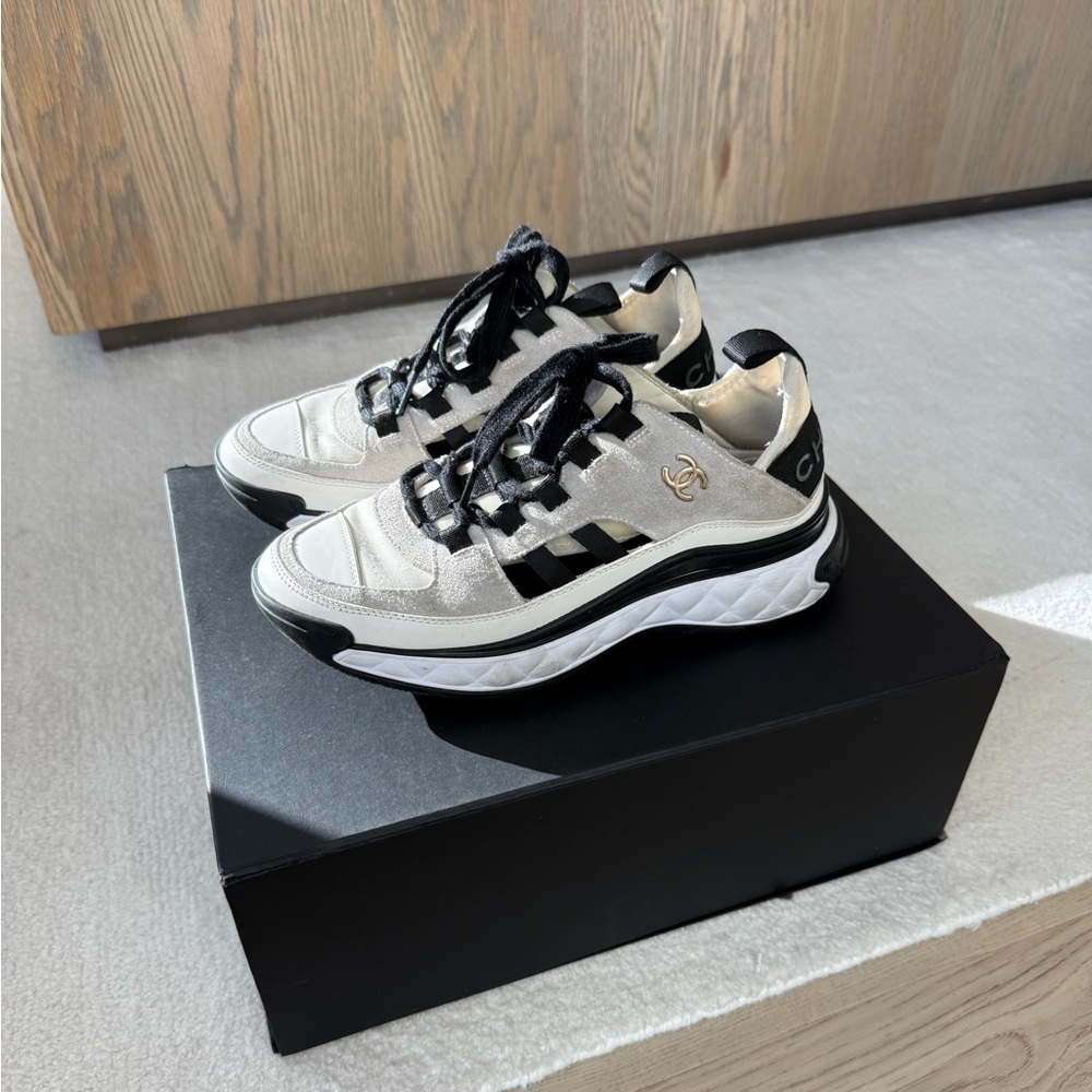 CHANEL Classic Sneakers in Ivory/White
Calfskin Suede + Gold Chanel Logo